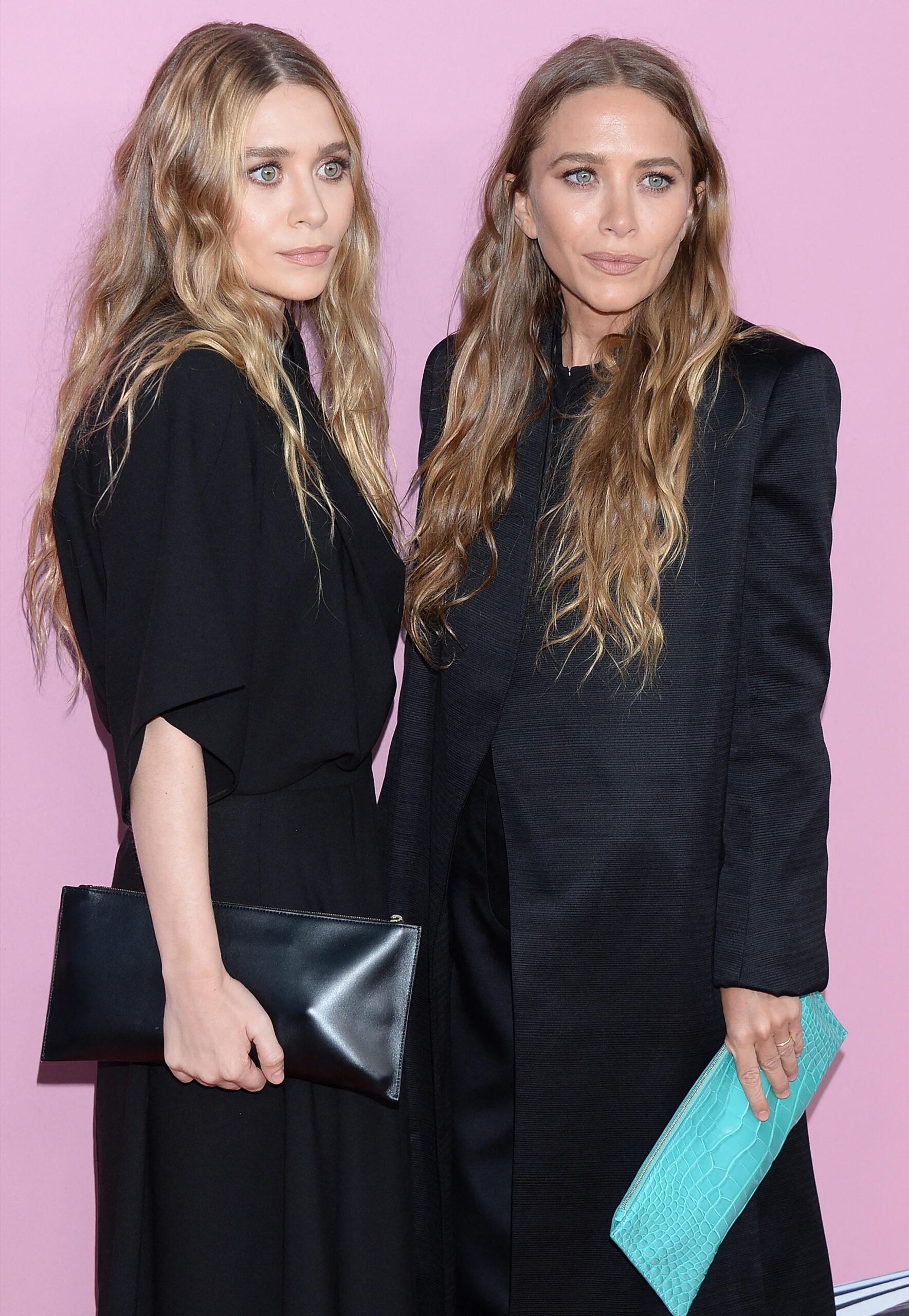 Ashley and Mary Kate Olsen posing together on the red carpet.