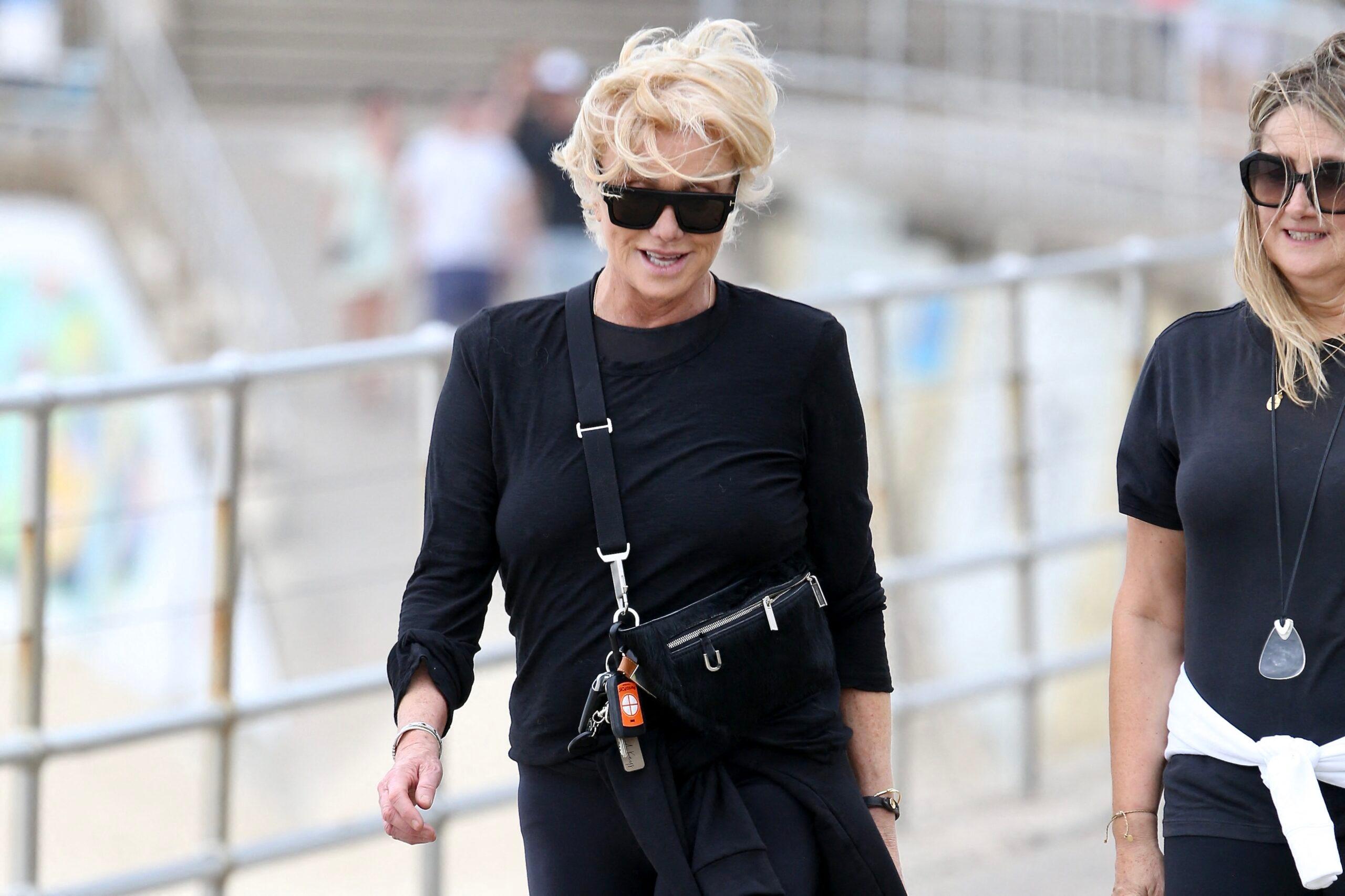 Deborra-Lee Furness braves a walk at a windy Bondi Beach with a friend