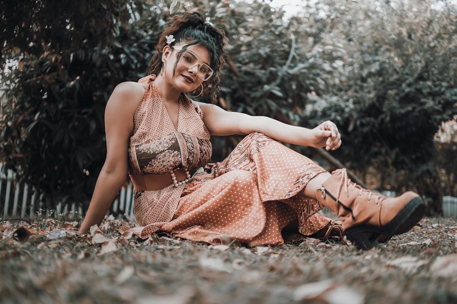 Woman wearing flowing bohemian style clothing with layered accessories and earthy tones