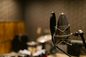 How Podcast Studios Are Becoming the New Hollywood Production Houses Professional recording studio with microphones and audio equipment setup for podcast production