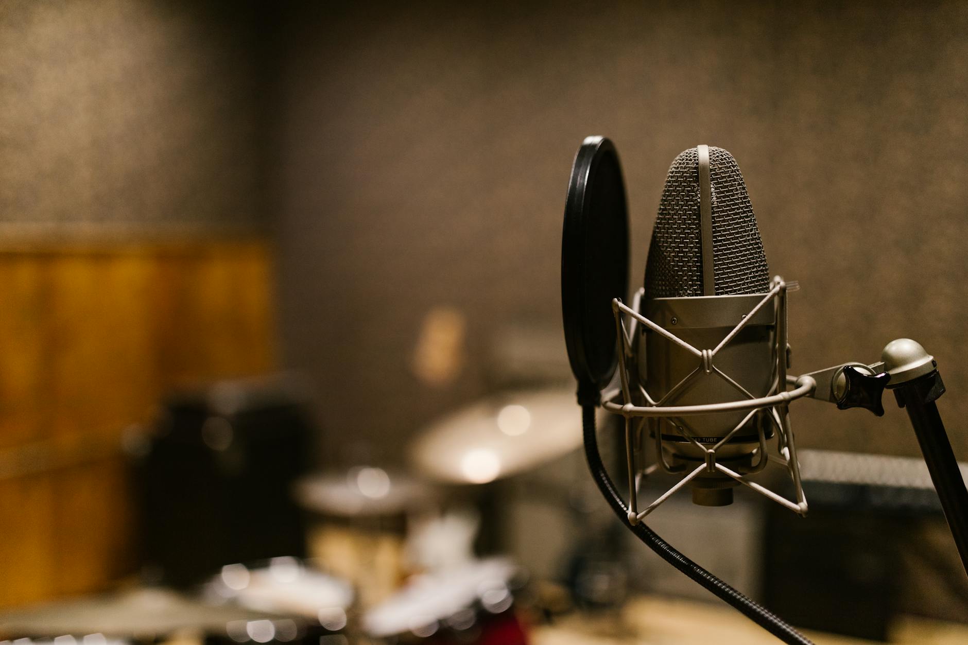 Professional recording studio with microphones and audio equipment setup for podcast production