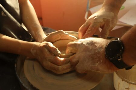 How Emma Stone’s Pottery Studio Is Becoming Hollywood’s Creative Retreat Hands working clay on a pottery wheel in a studio setting