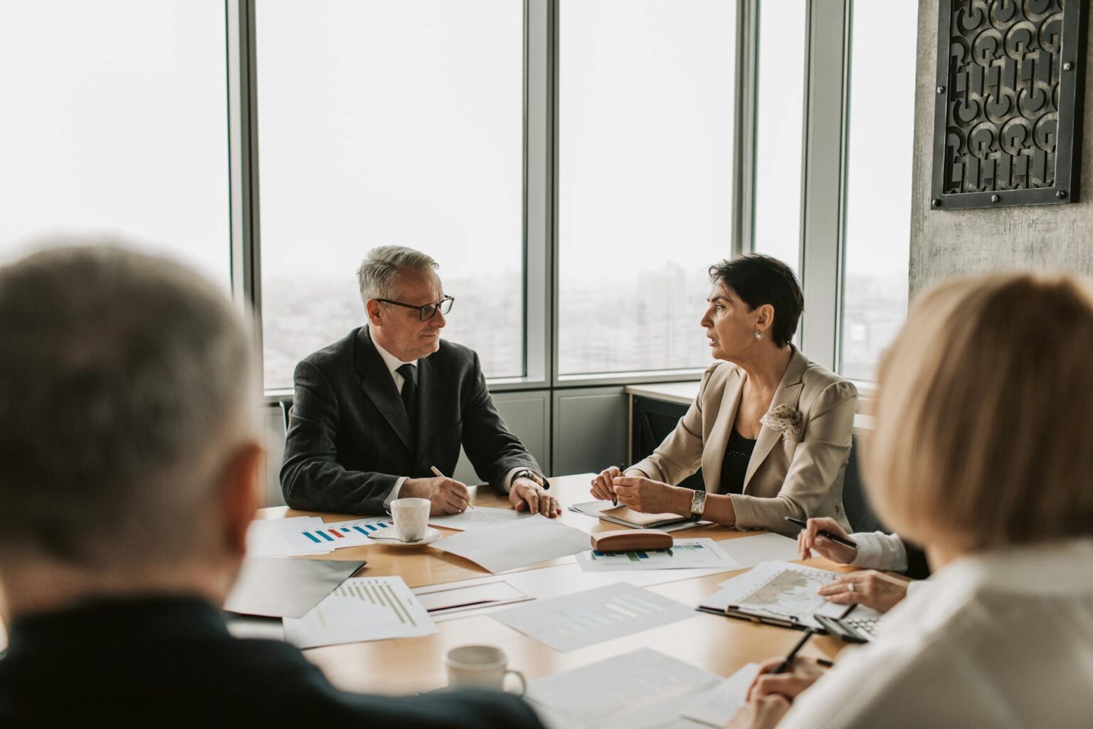 Why Tech Executives Are Hiring Professional Habit Formation Coaches Professional business meeting in modern office setting with executives discussing strategy