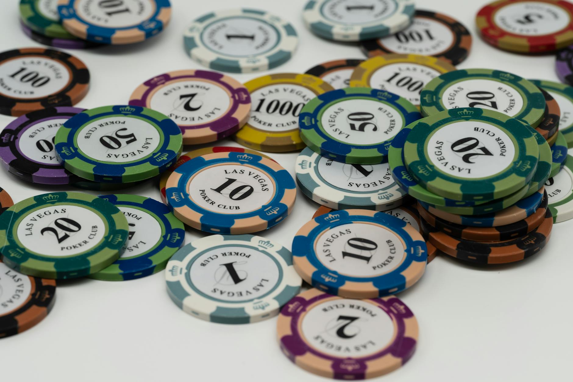 Professional poker chips stacked on green felt table surface