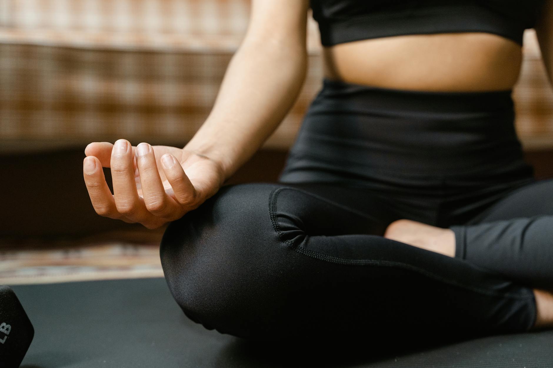 Person meditating in peaceful wellness setting with natural lighting