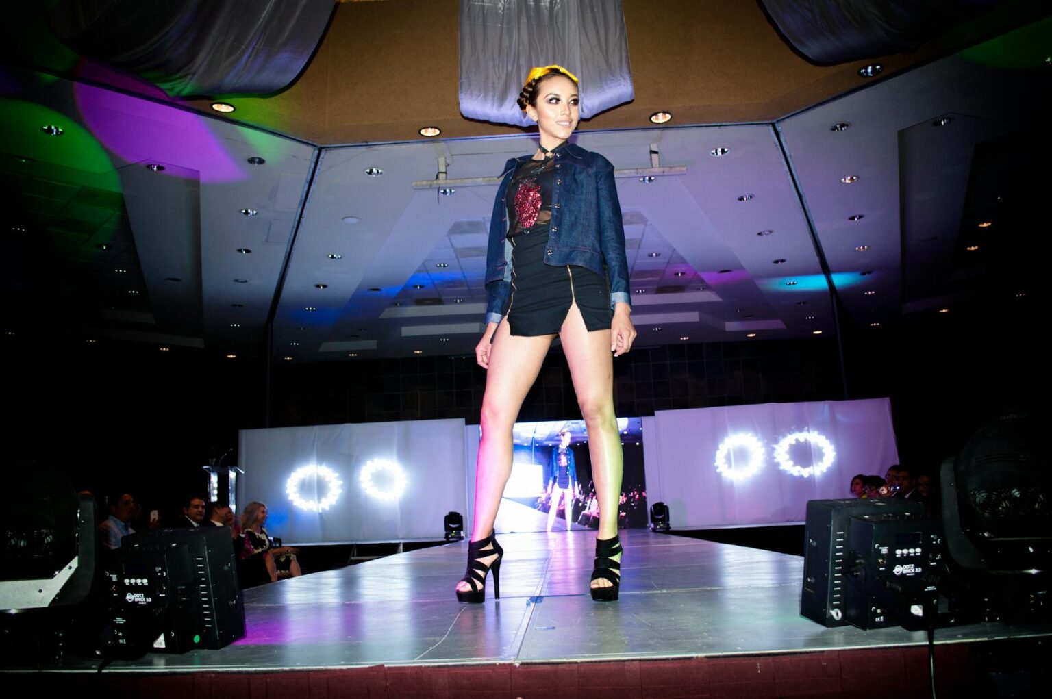 How Social Media Is Killing Traditional Fashion Week Coverage Fashion runway show with models walking and audience seated watching the presentation