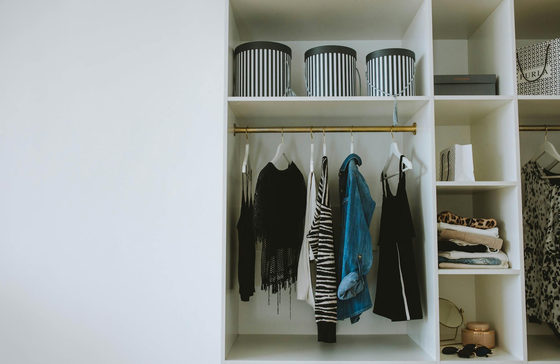 Professional wardrobe with hanging designer clothes and accessories for styling