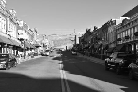 Why A-Listers Are Investing in Small-Town Real Estate Markets Quiet main street in small American town with historic buildings and wide sidewalks