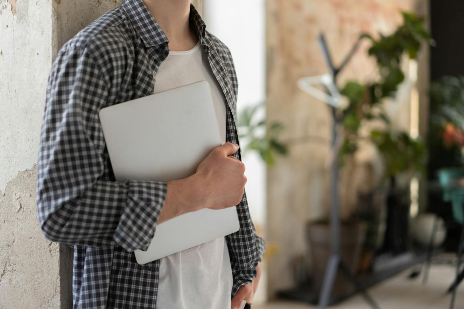 Young professional working on laptop in modern office space