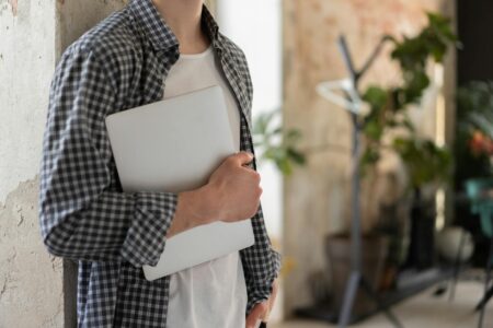 Young professional working on laptop in modern office space