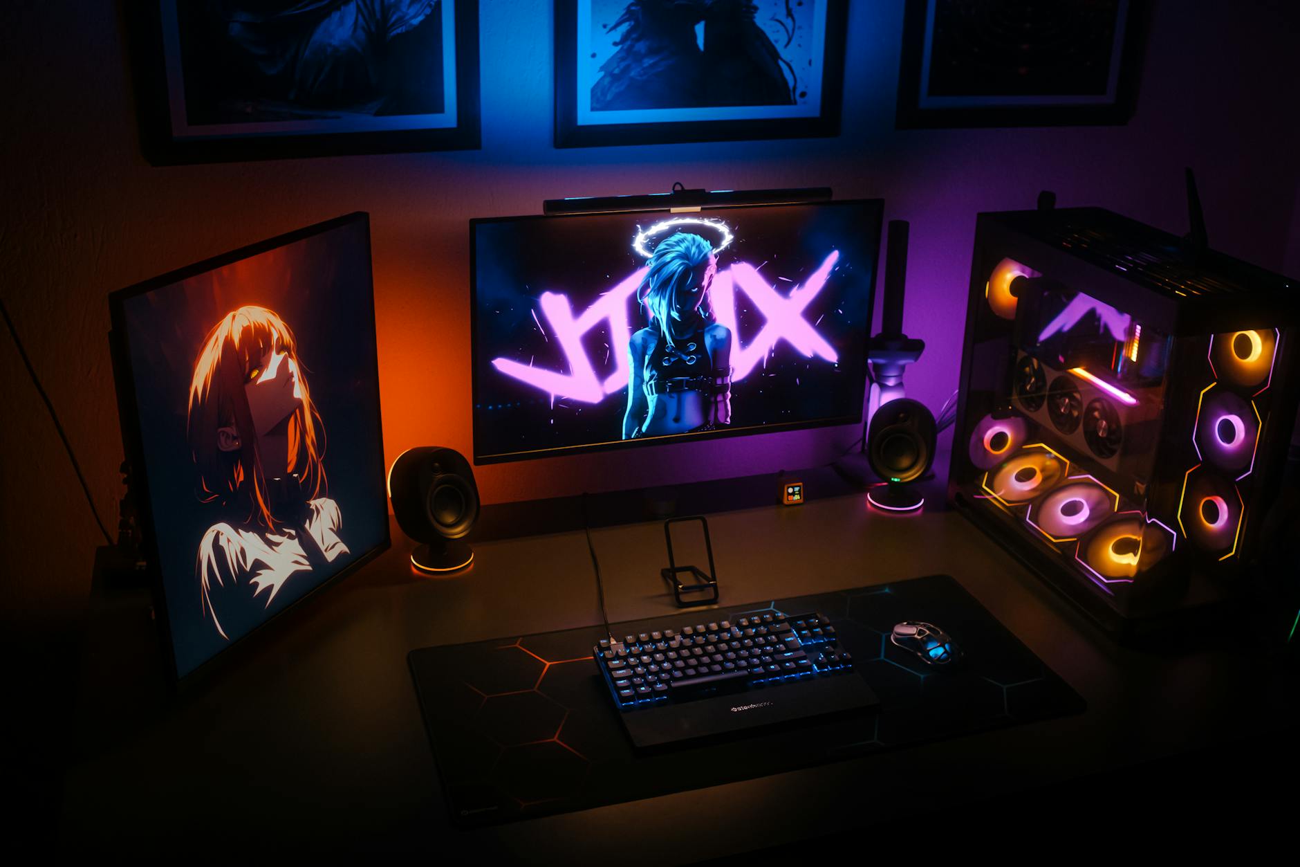 Professional gaming setup with multiple monitors, RGB lighting, and streaming equipment in dark room