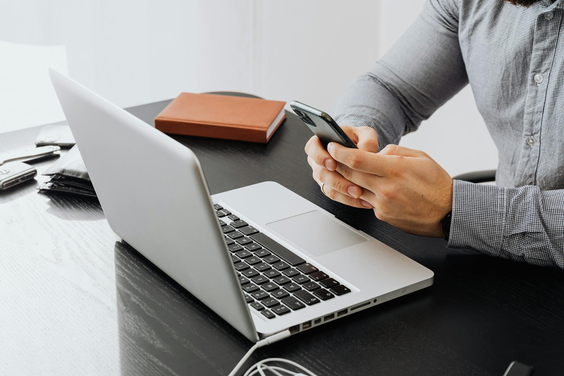 Business desk with smartphone and laptop showing digital workspace setup