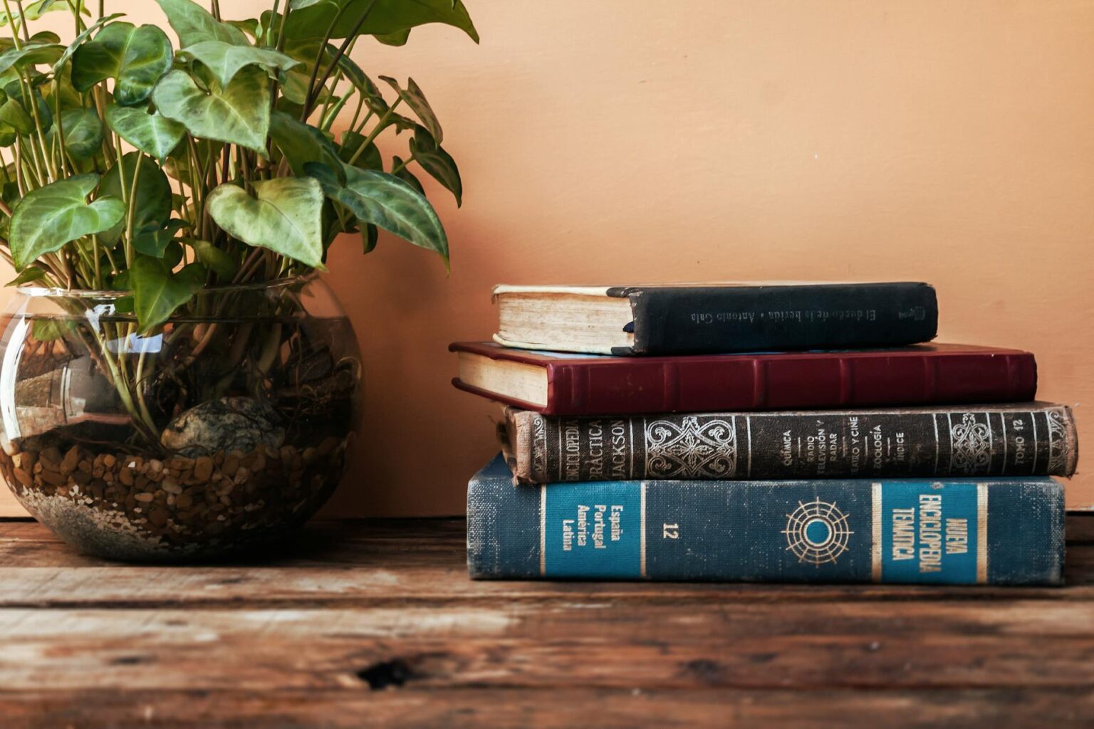 Stack of books on wooden table representing book club selections
