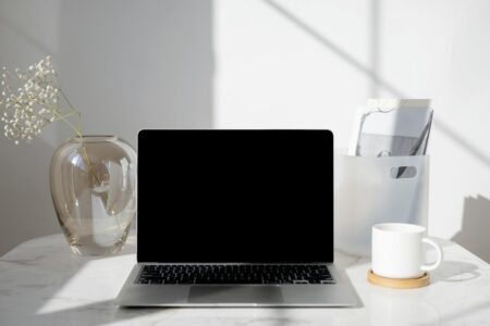 Modern laptop workspace setup with clean desk and professional lighting