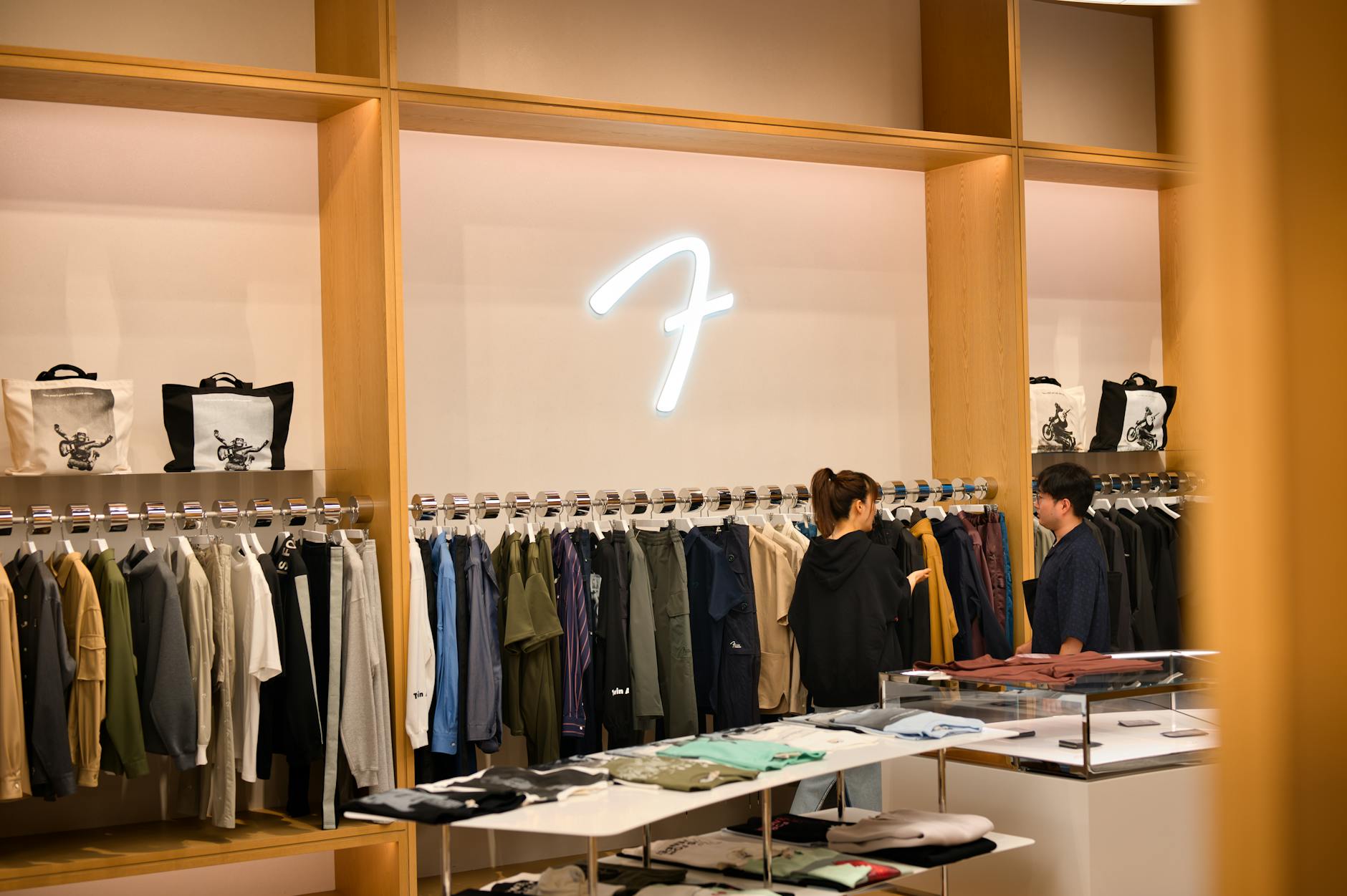 Modern fashion retail store interior with clothing displays and contemporary lighting