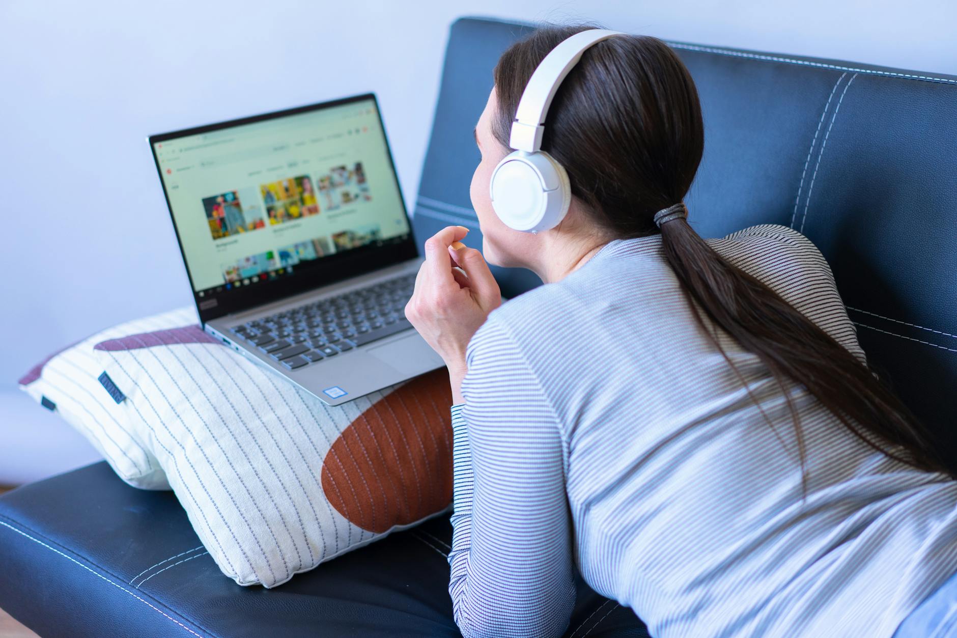Person watching streaming content on laptop screen