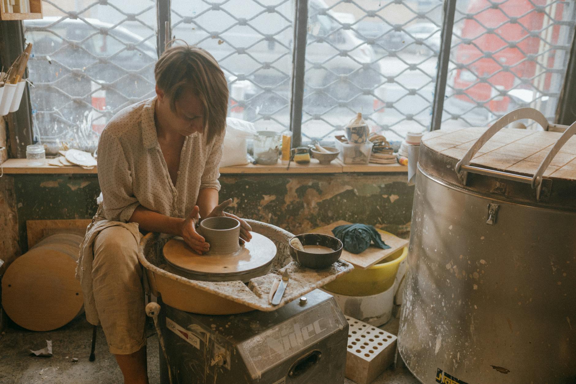 Interior of pottery studio with ceramic pieces and art supplies