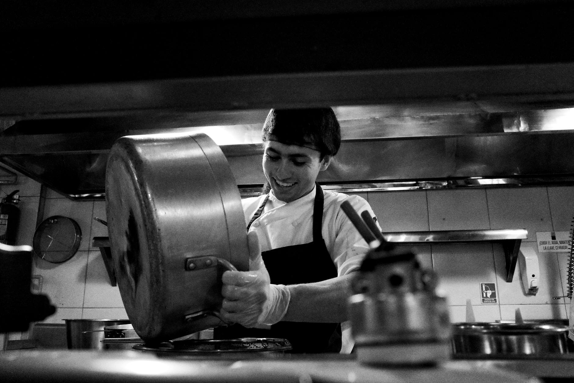 Professional chef preparing food in commercial restaurant kitchen
