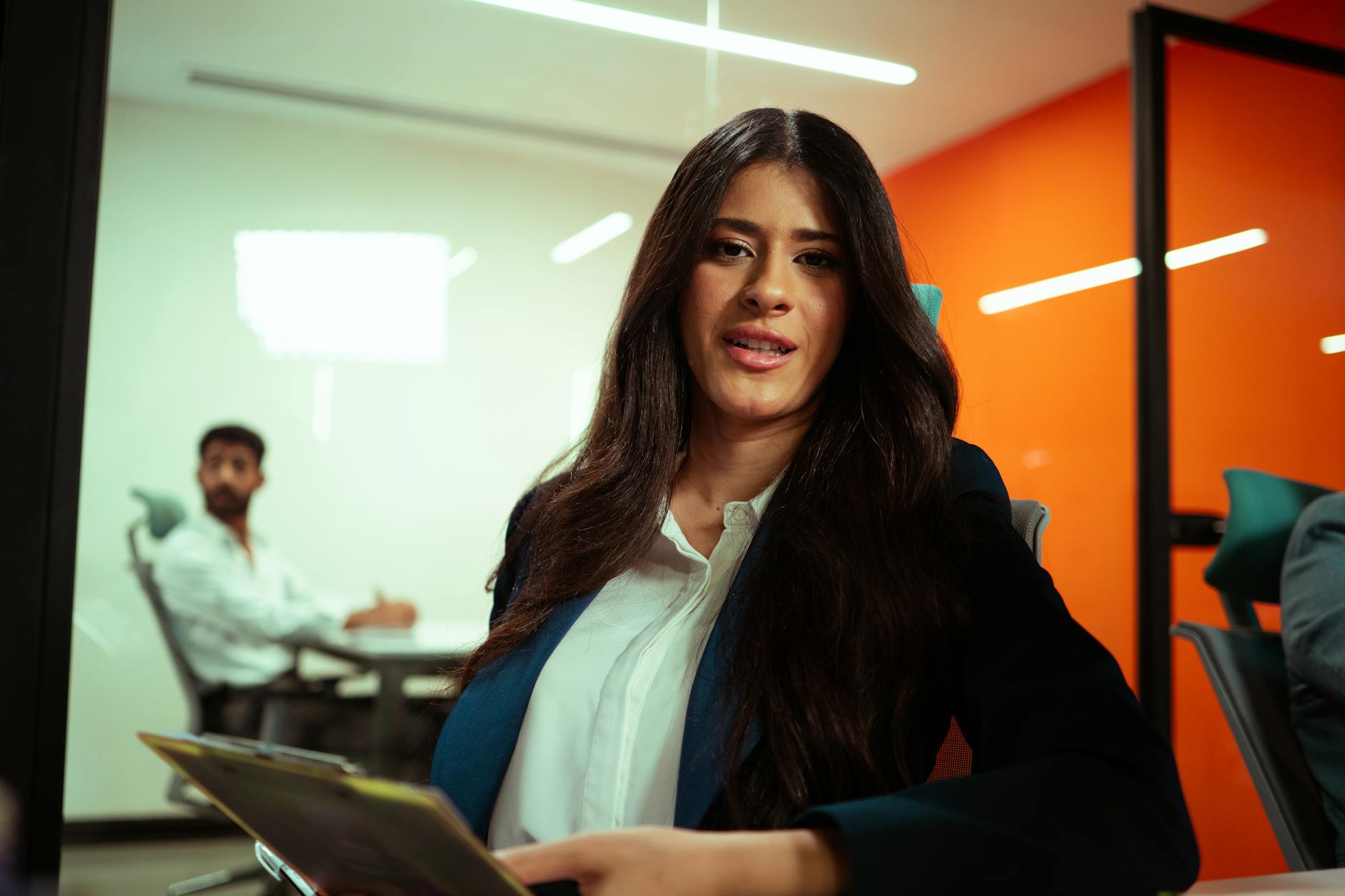 Professional woman in business attire during a meeting discussion