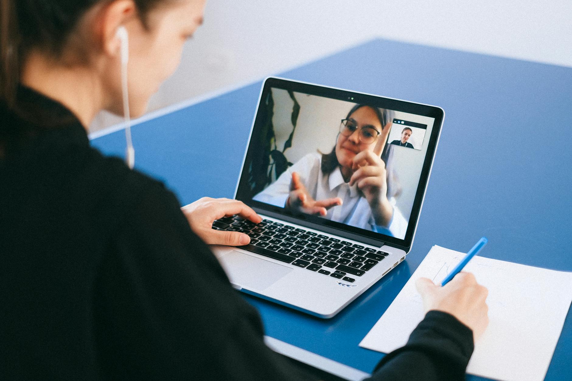 Person participating in video conference call on computer screen