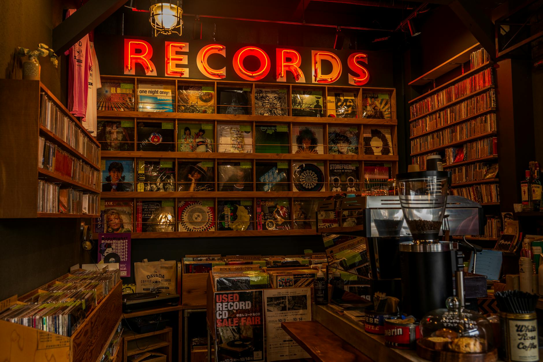 Interior of a record store with vinyl albums displayed on shelves and listening stations
