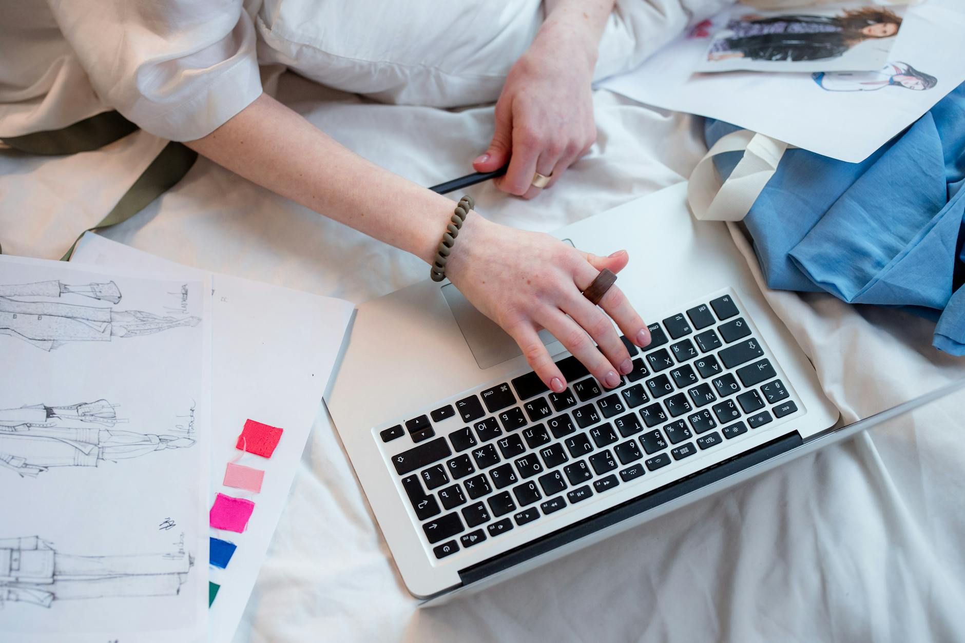 Fashion stylist arranging clothes and accessories on a table