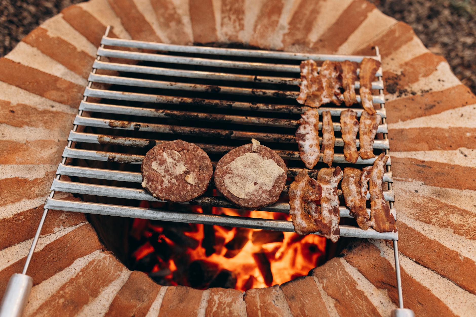Chef preparing gourmet burger with fresh ingredients on cooking surface