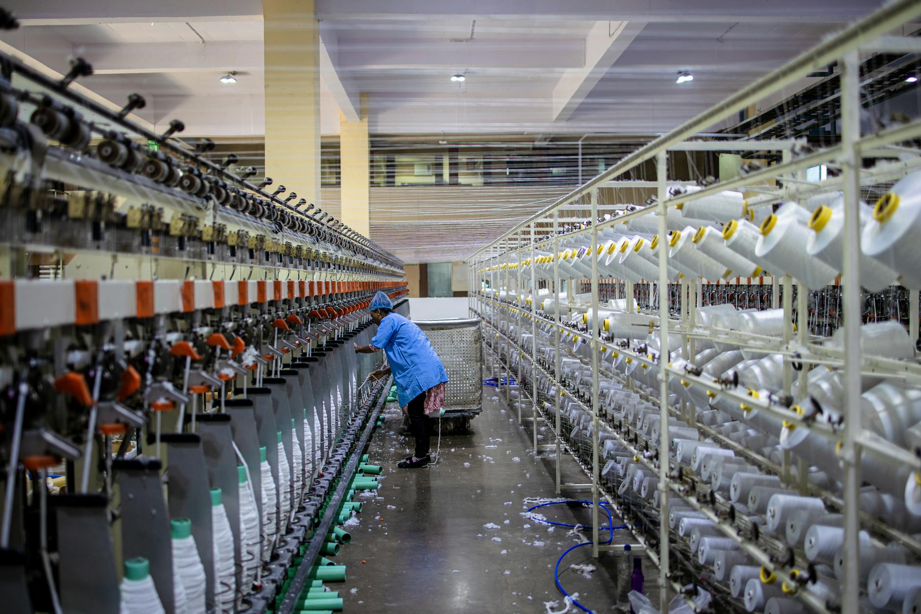 Modern textile manufacturing equipment producing sustainable fabrics in a clean factory setting
