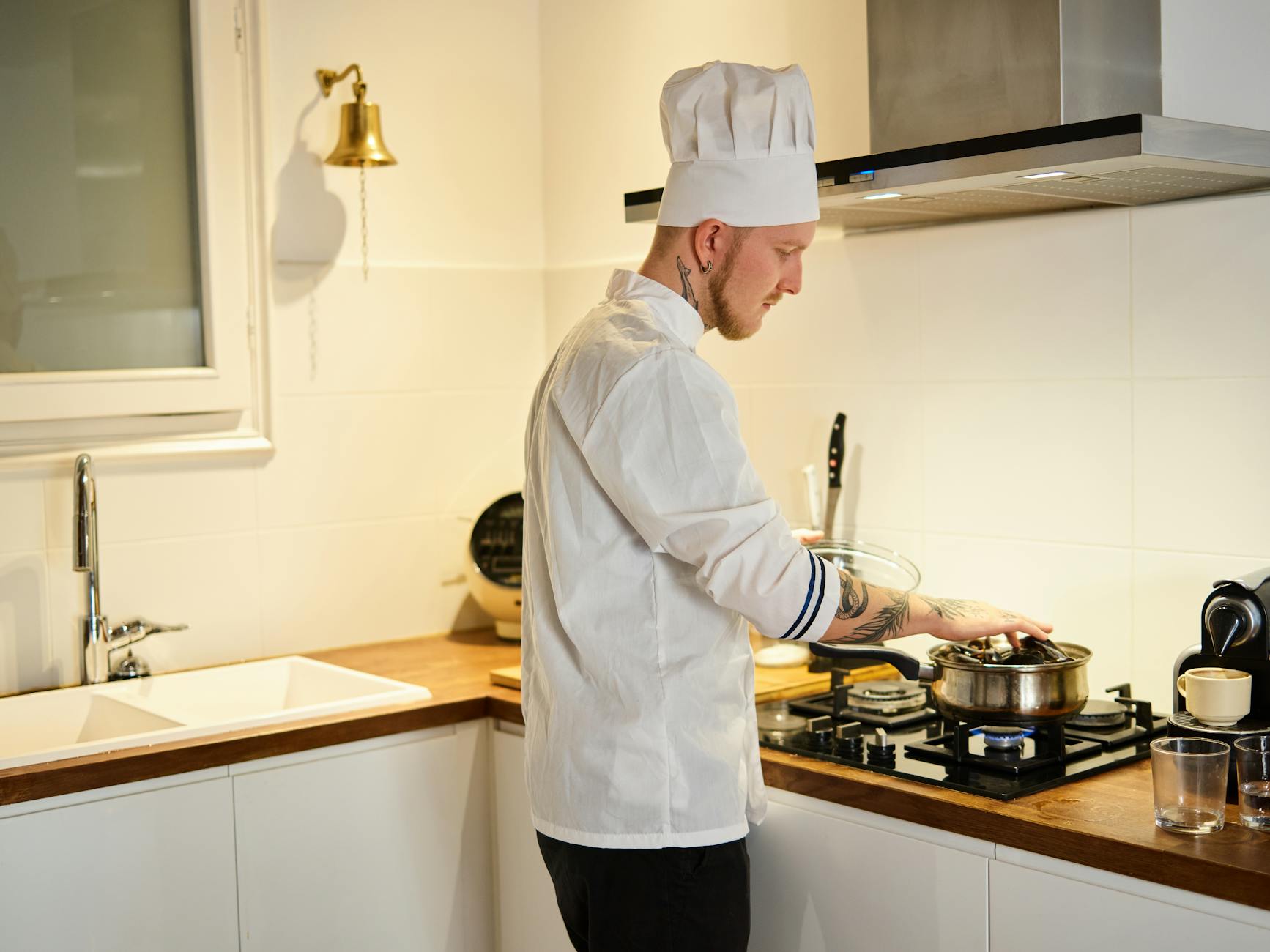 Professional chef preparing traditional dishes in modern restaurant kitchen