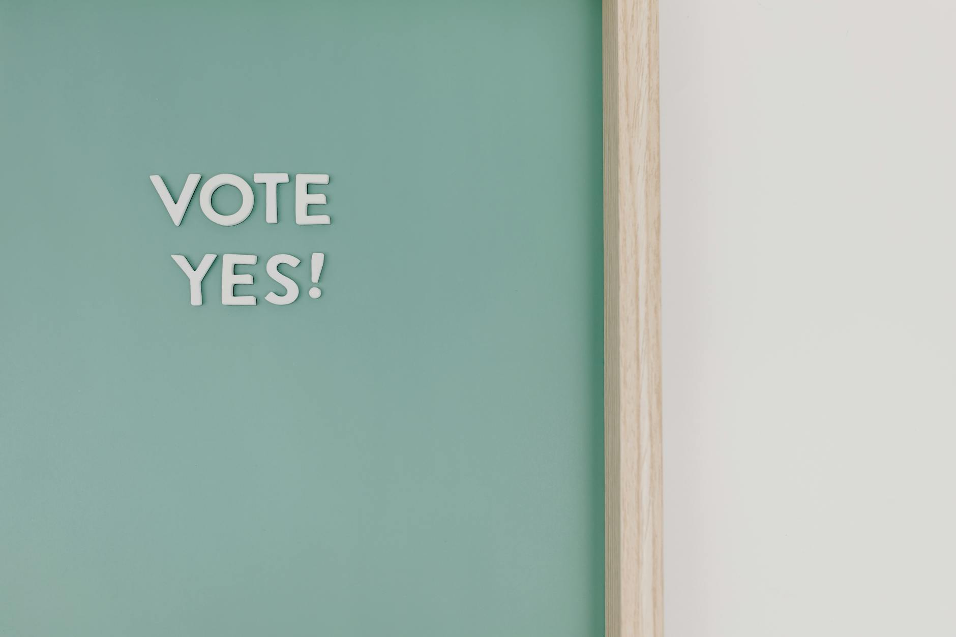 Hand holding smartphone displaying voting interface with multiple choice options