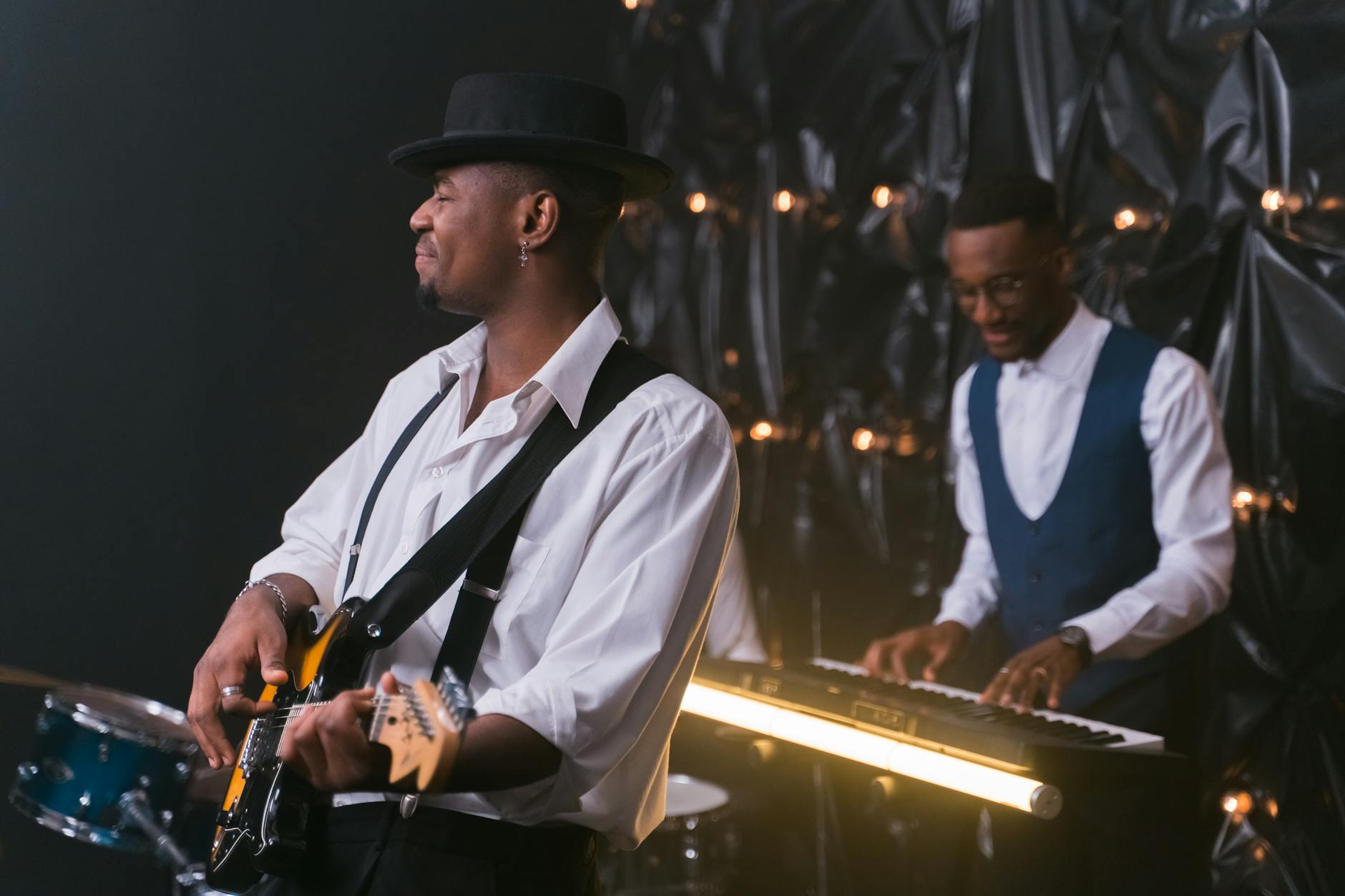 Artist performing on stage with dramatic lighting