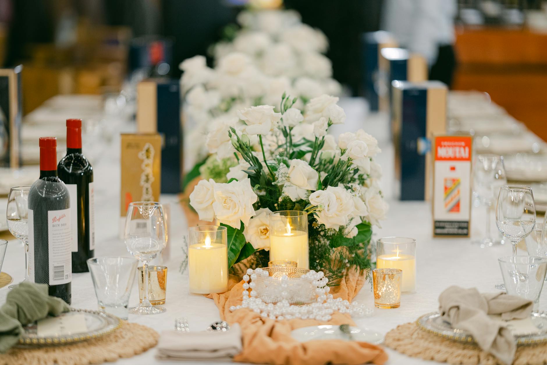 Upscale dinner party setting with guests engaged in conversation around formal dining table