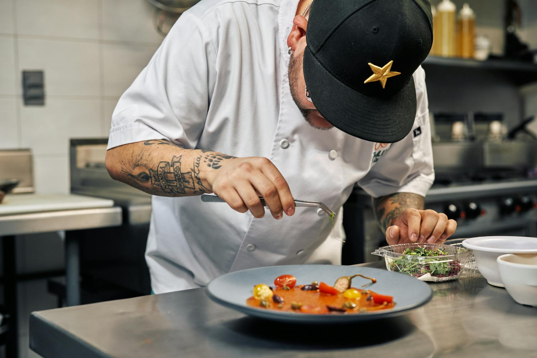 Chef's hands artfully plating gourmet dish with professional presentation