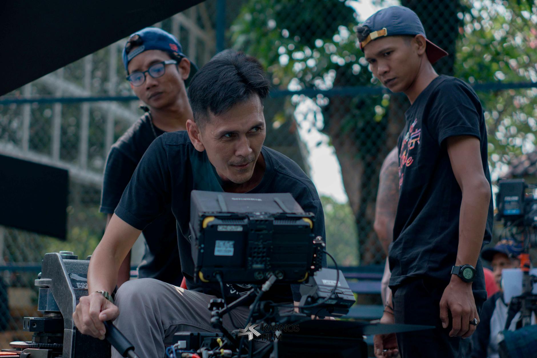 Behind-the-scenes view of professional film set with dramatic lighting equipment