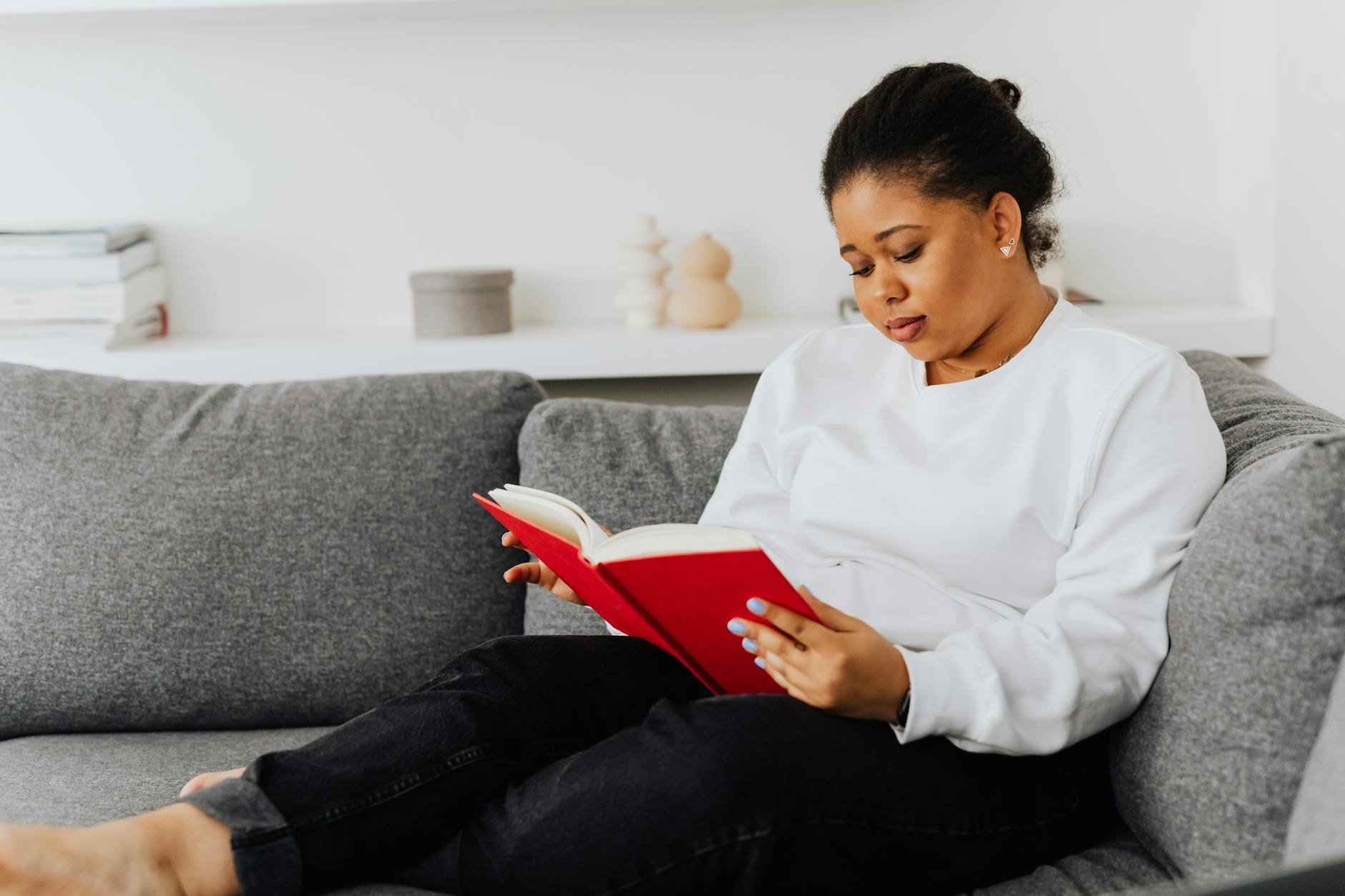 Woman reading a book in comfortable indoor setting