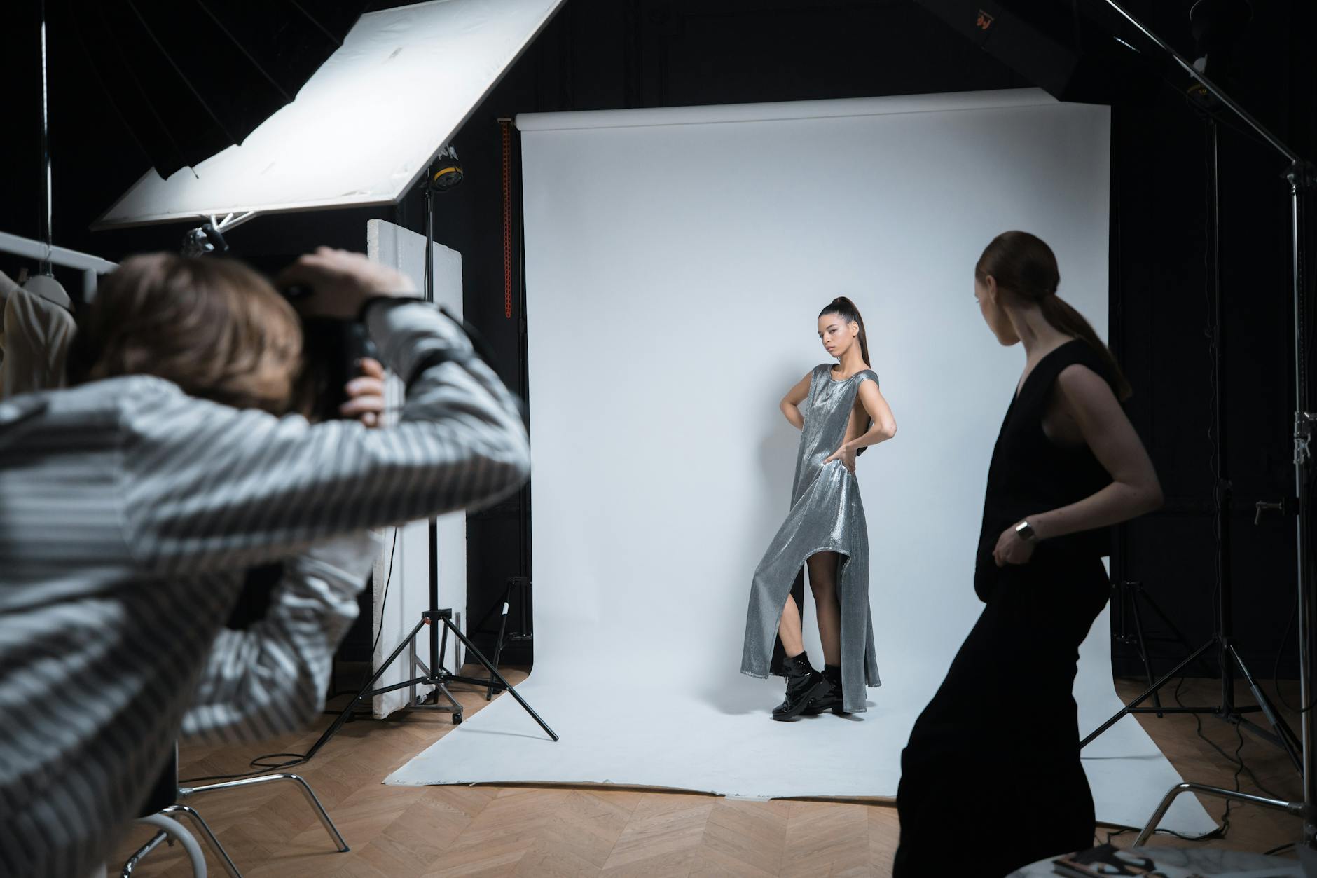 Professional photography studio setup with lighting equipment and fashion backdrop for clothing shoots