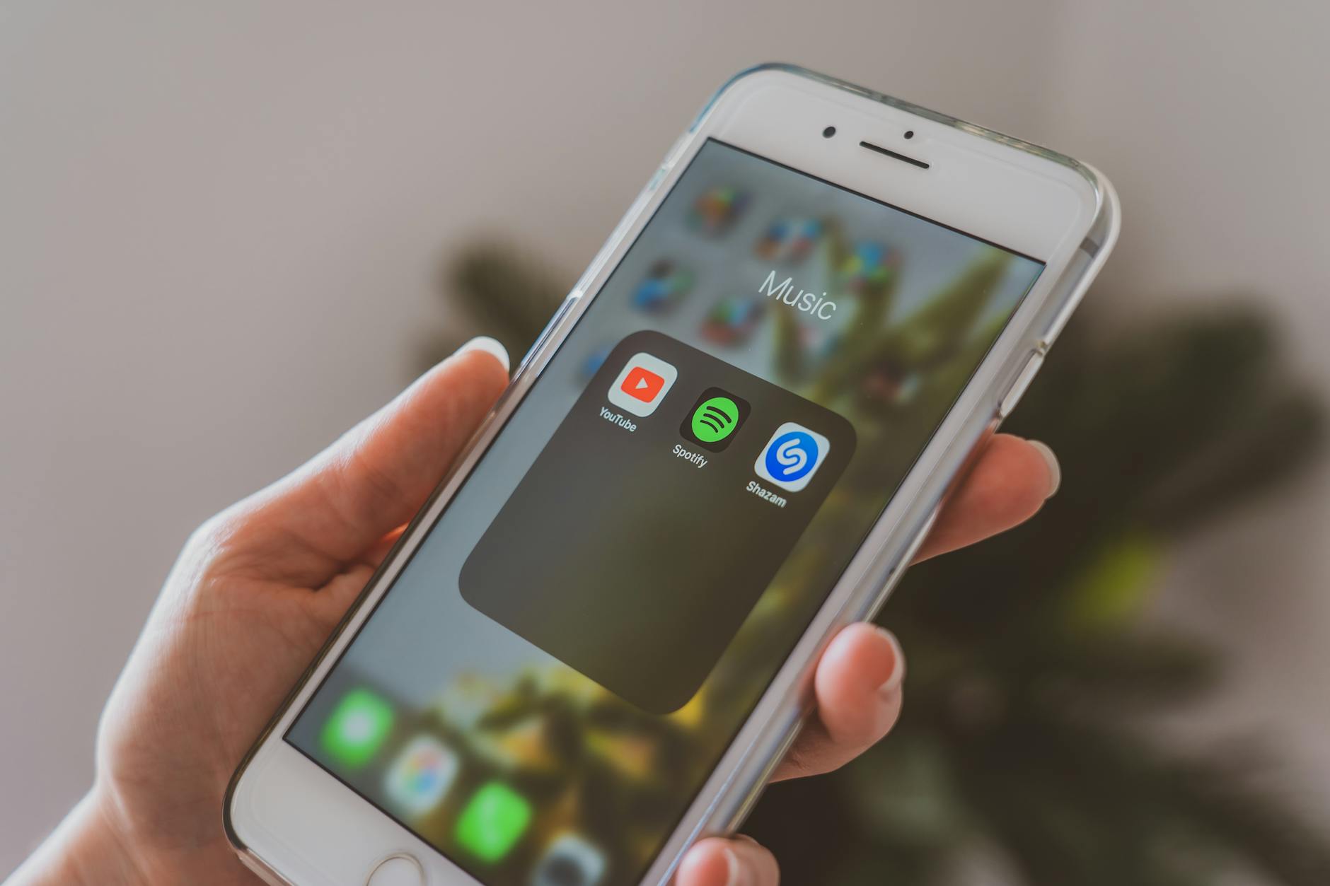 Person watching comedy content on mobile phone screen in dark room