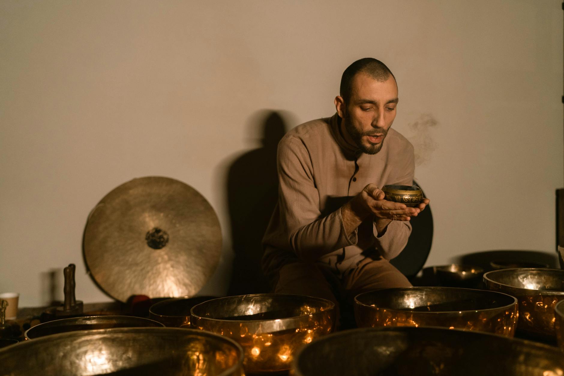 Collection of crystal singing bowls, gongs, and chimes used in professional sound bath therapy sessions