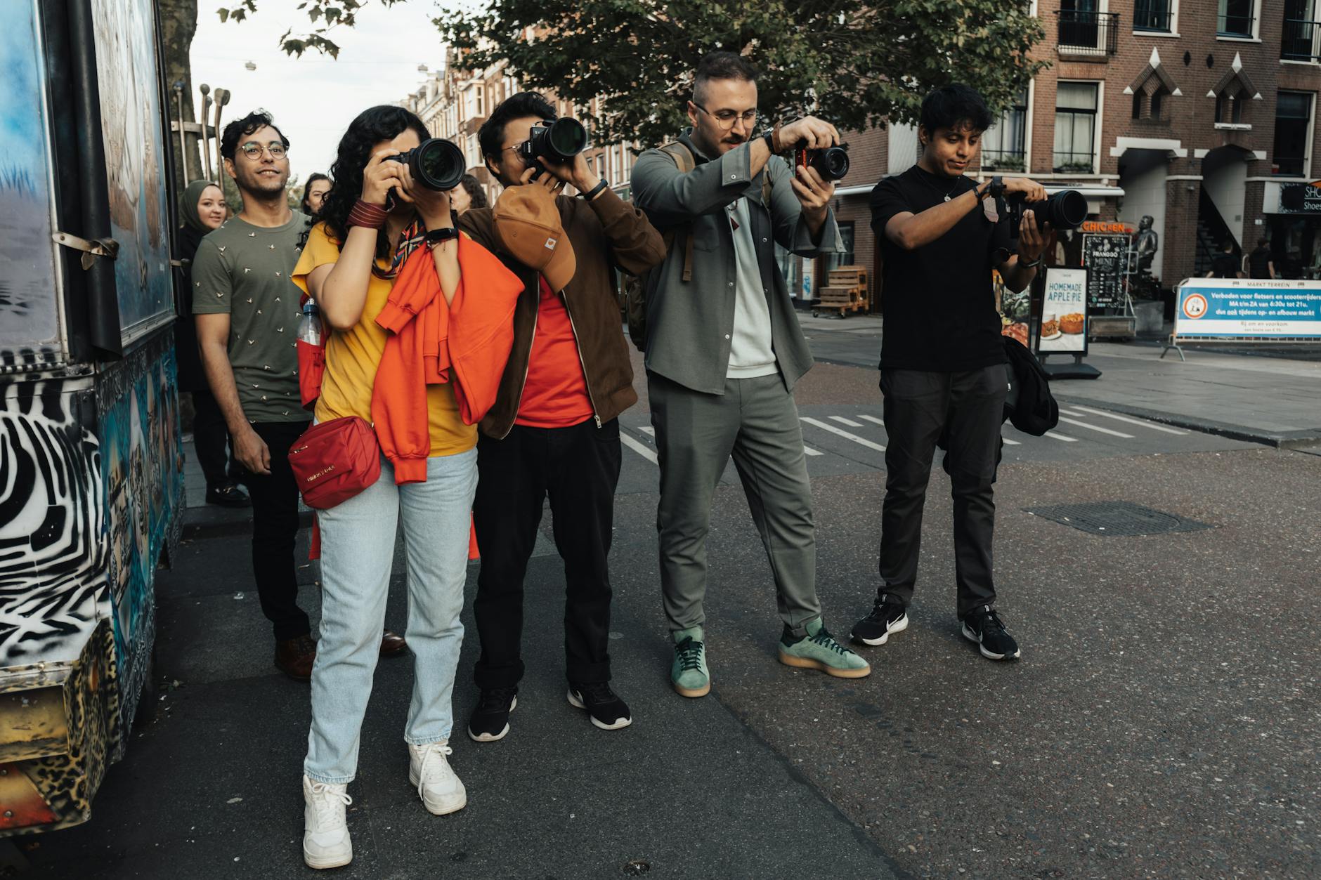 Fashion photographer capturing street style looks with professional camera equipment