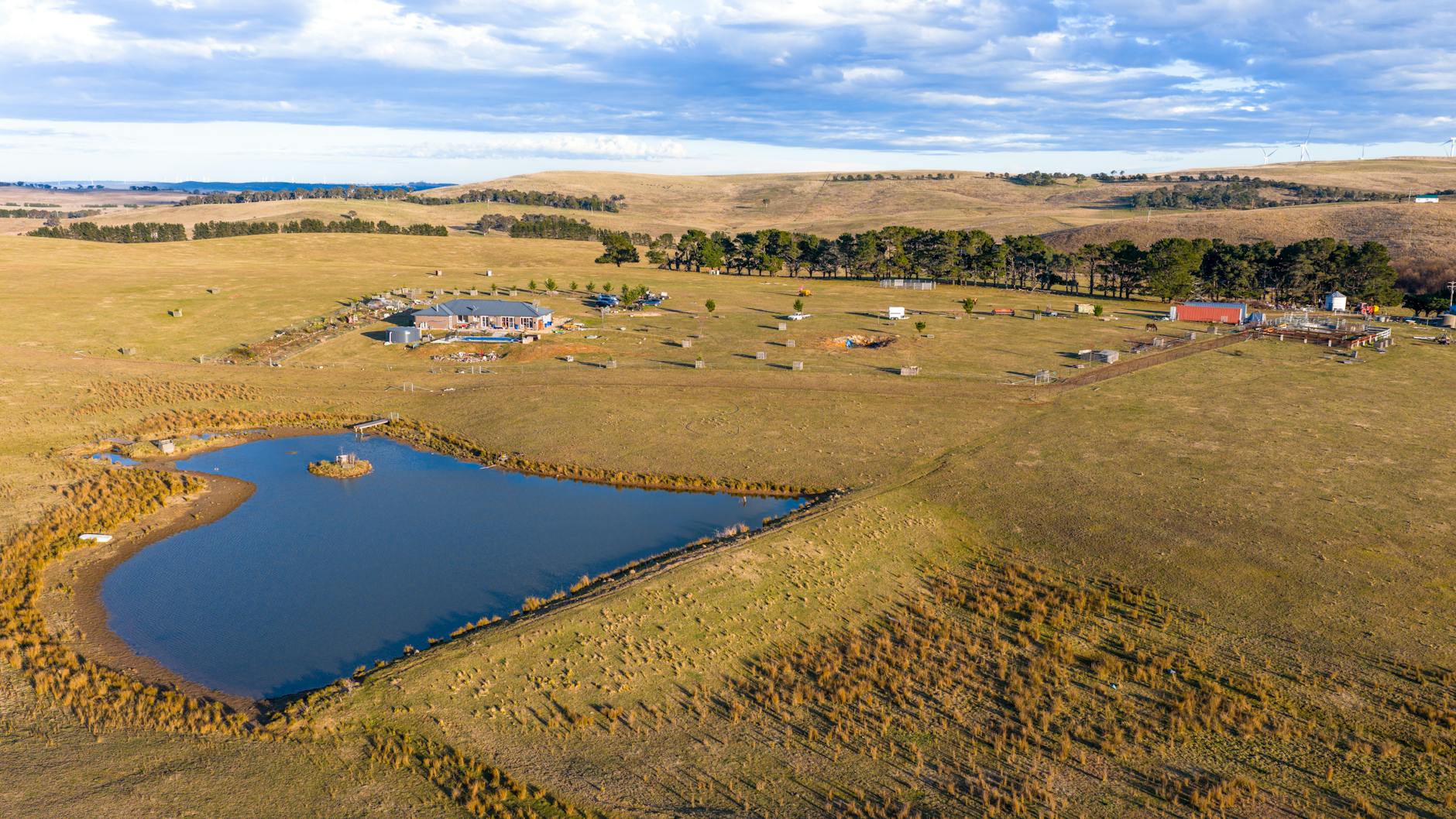 Aerial view of expansive rural property with farmland and wooded areas