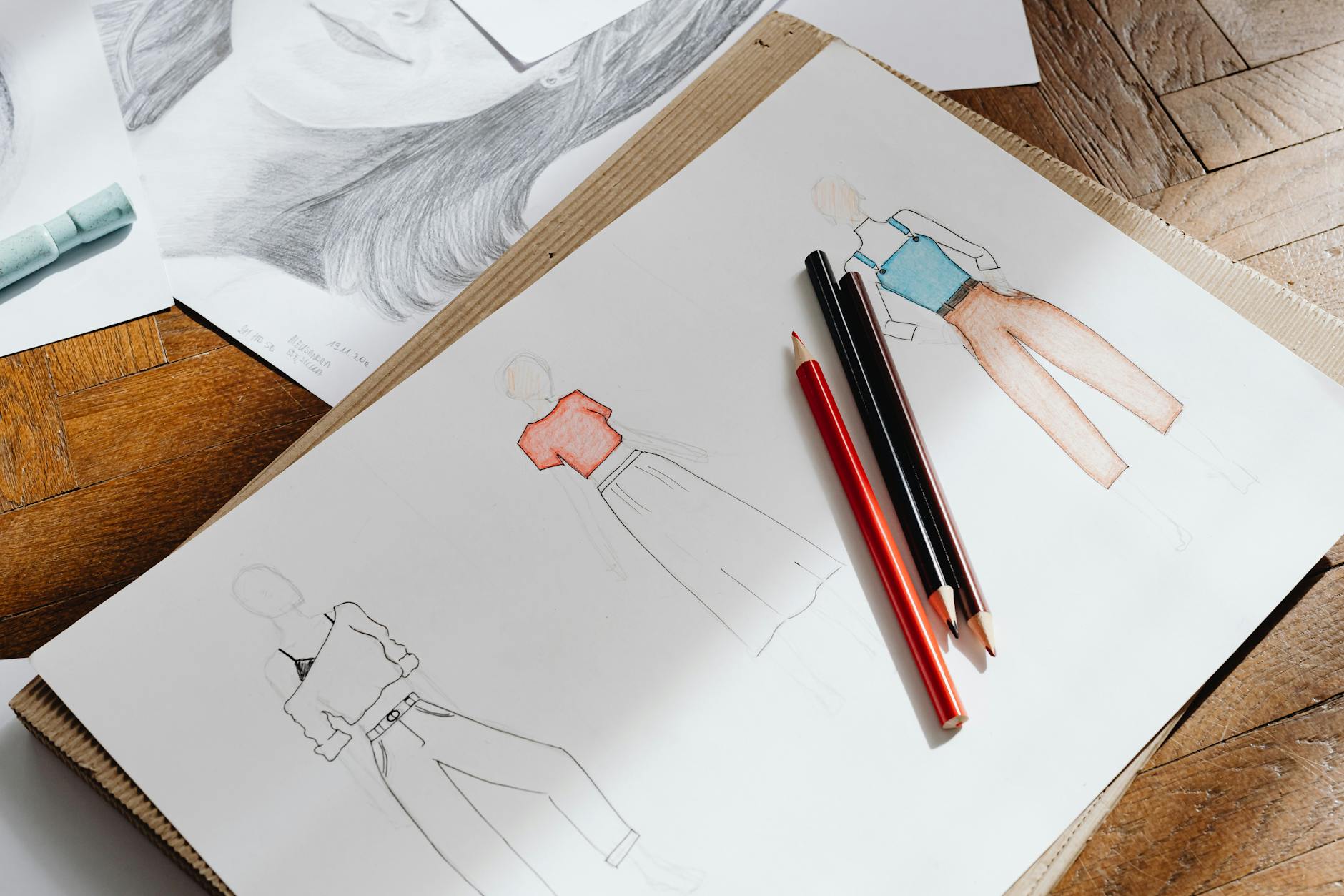 Close-up of fashion design sketches and creative planning materials