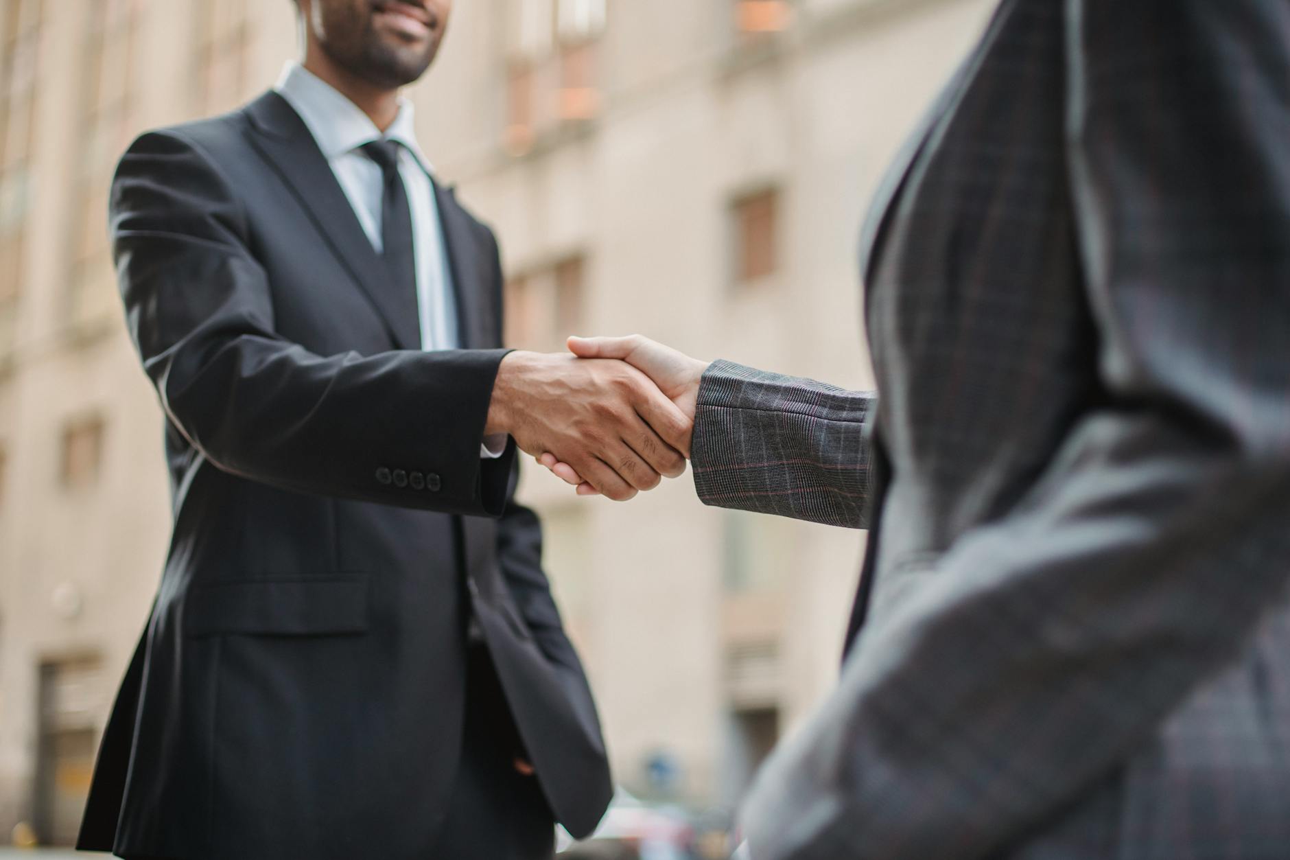 Professional business handshake representing successful deal negotiation and partnership