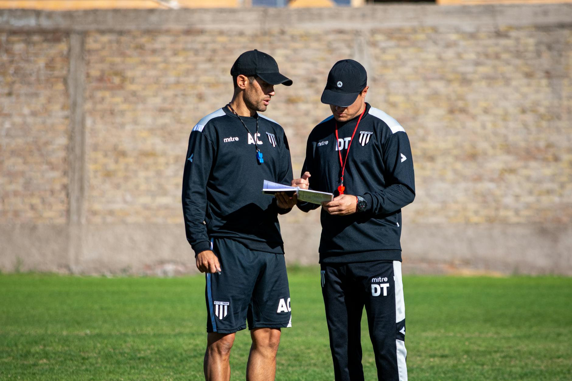 Professional coach working one-on-one with young student at computer workstation