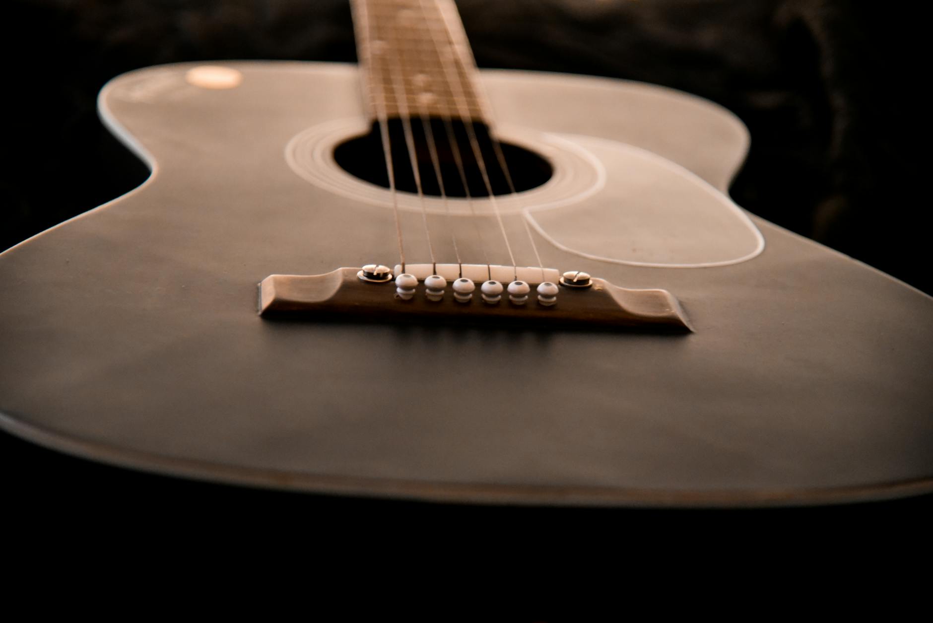 Acoustic guitar on wooden surface symbolizing songwriting creativity