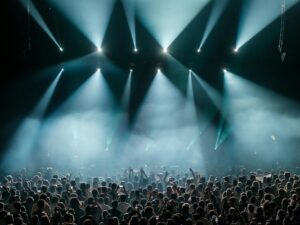 Billie Eilish’s Tour Production Design Is Influencing Live Concert Staging Dramatic concert stage with atmospheric lighting and low-profile production design