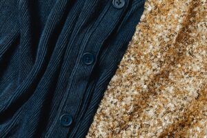 Celebrities Keep Reaching for Loro Piana’s Under-the-Radar Knitwear Folded cashmere sweaters in neutral tones displayed on a clean surface