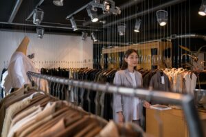 Net-a-Porter’s Quiet Shift Toward Emerging Designer Exclusives Curated luxury clothing displayed on racks in an upscale fashion boutique