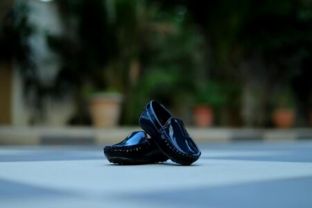 Loro Piana’s Cashmere Loafers Are Replacing Designer Sneakers Close-up of elegant slip-on loafers in soft neutral fabric on a polished floor