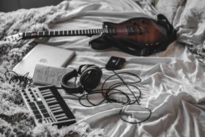 Olivia Rodrigo’s Label Is Quietly Signing Bedroom Pop Artists A young artist recording music in a home bedroom studio setup with a laptop and microphone