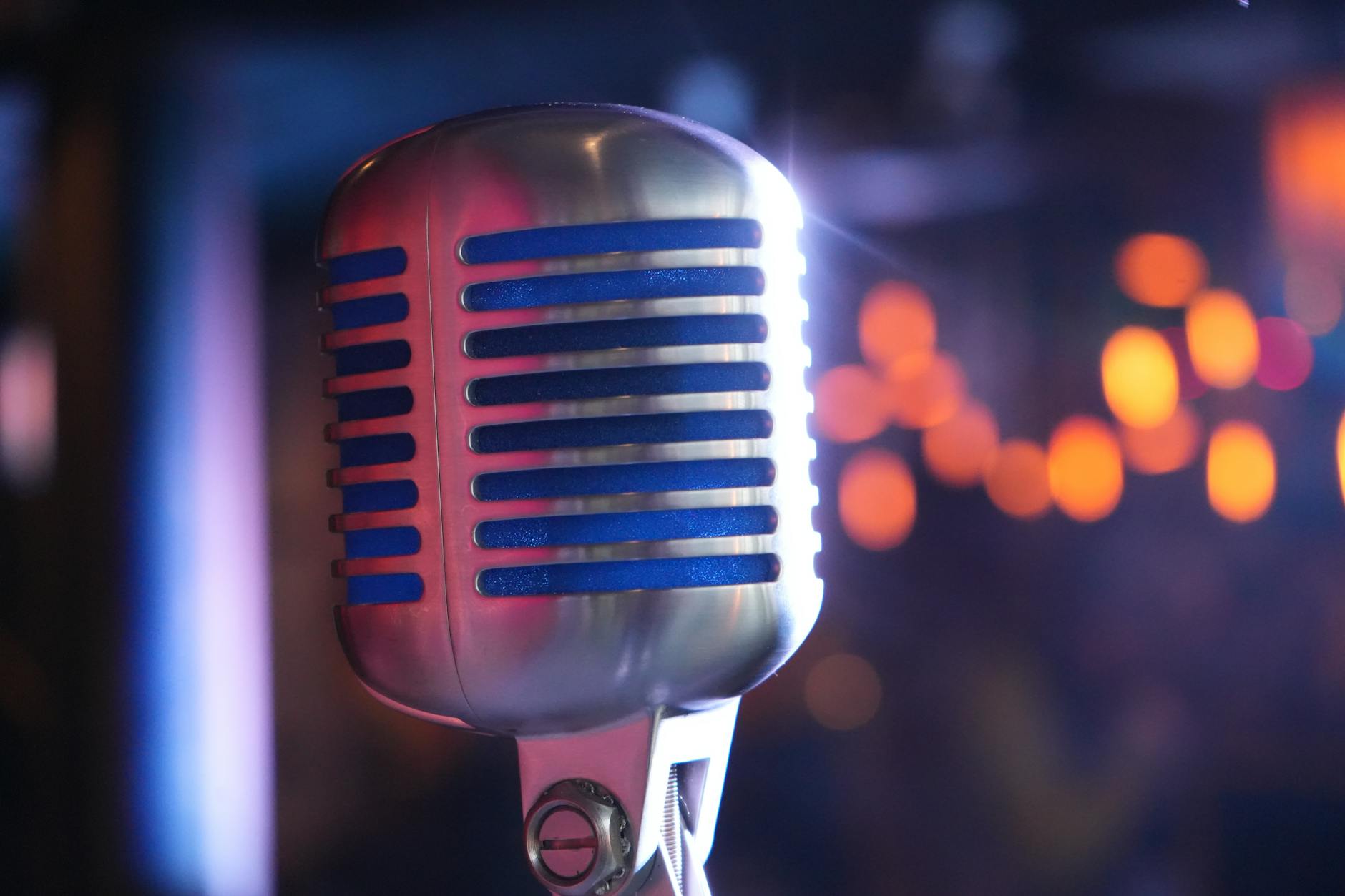 Professional microphone on dimly lit comedy club stage with spotlights